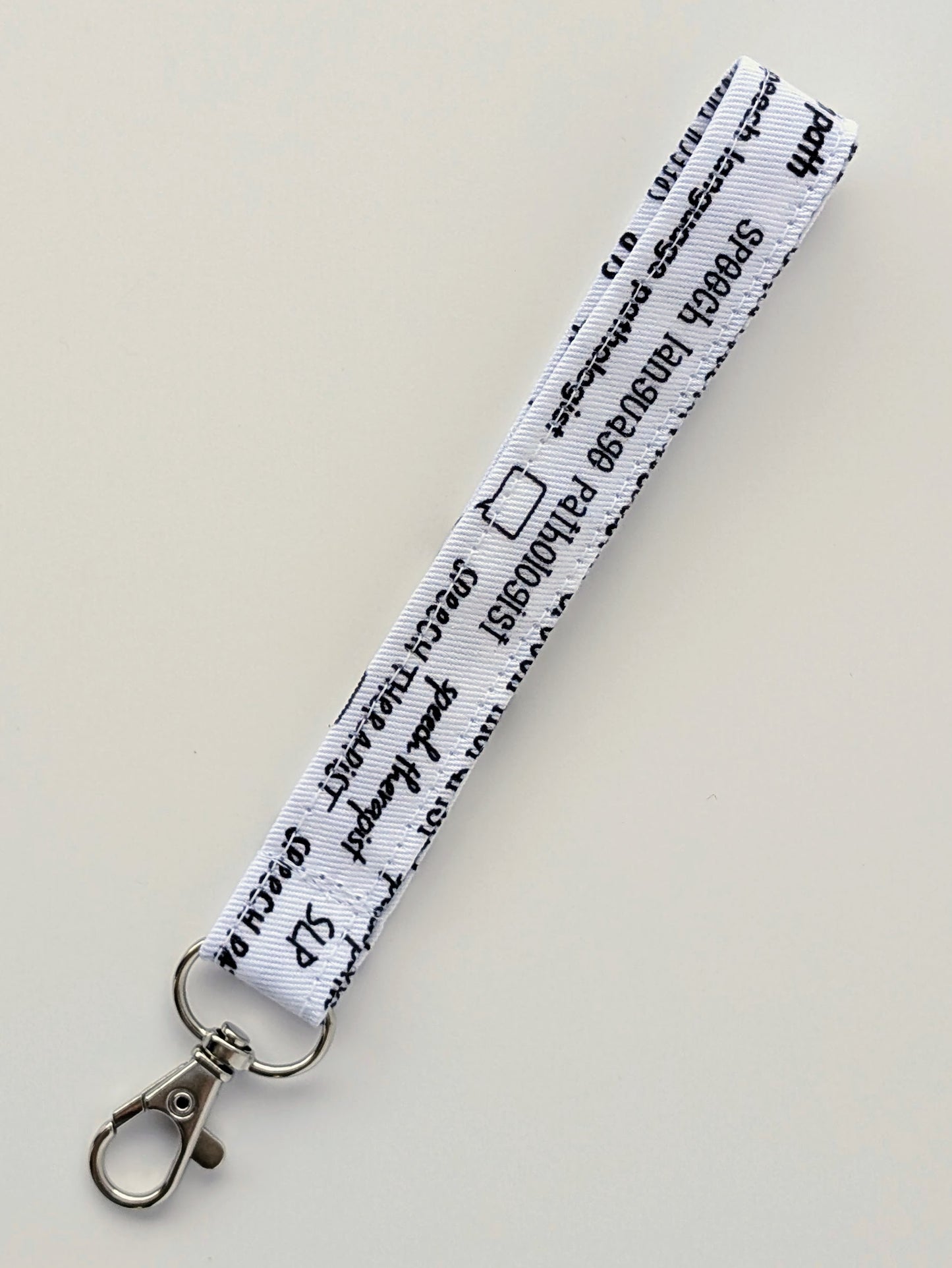 White keychain clip on a light gray background