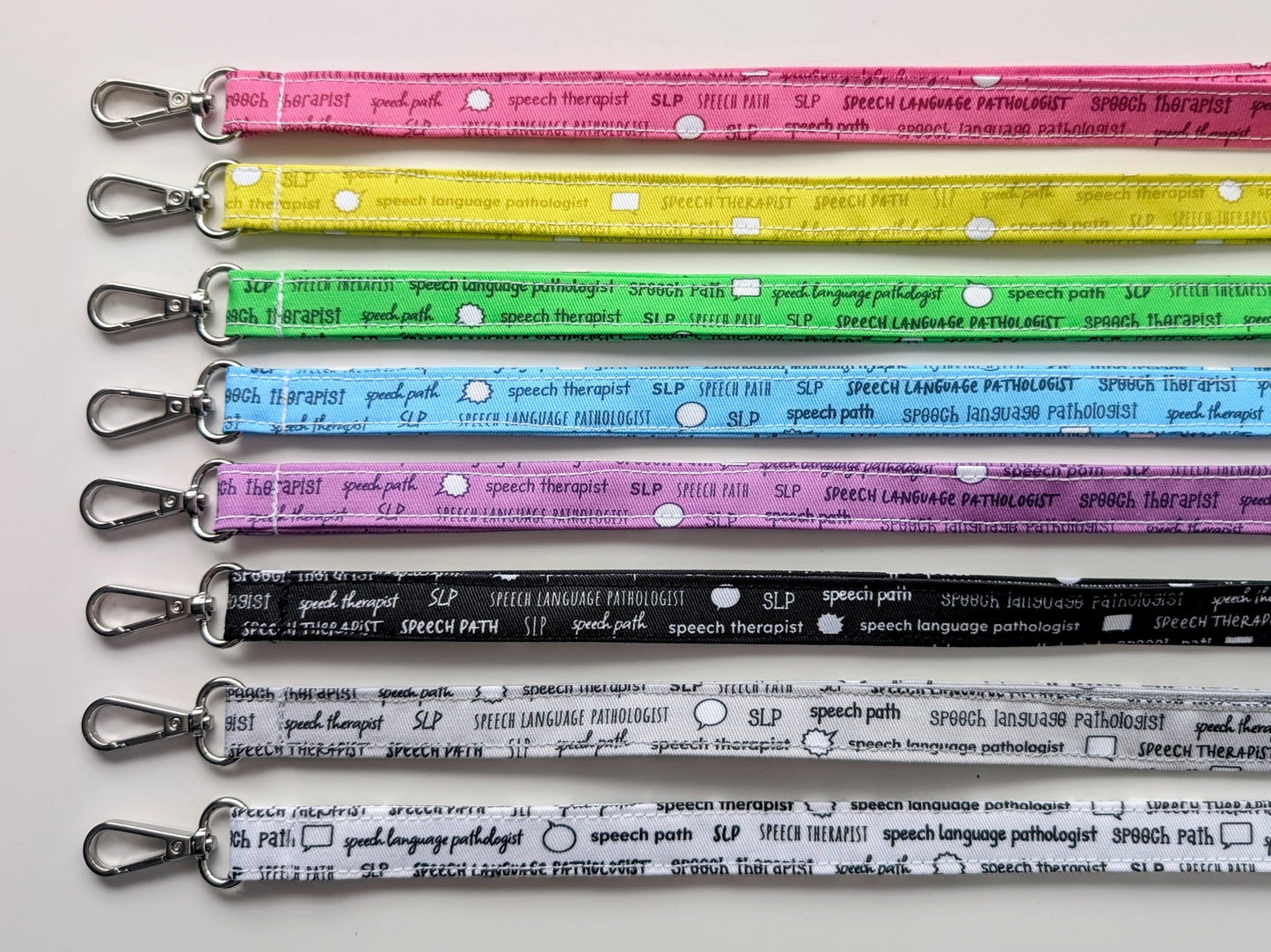 Set of colorful lanyards with text on a white background
