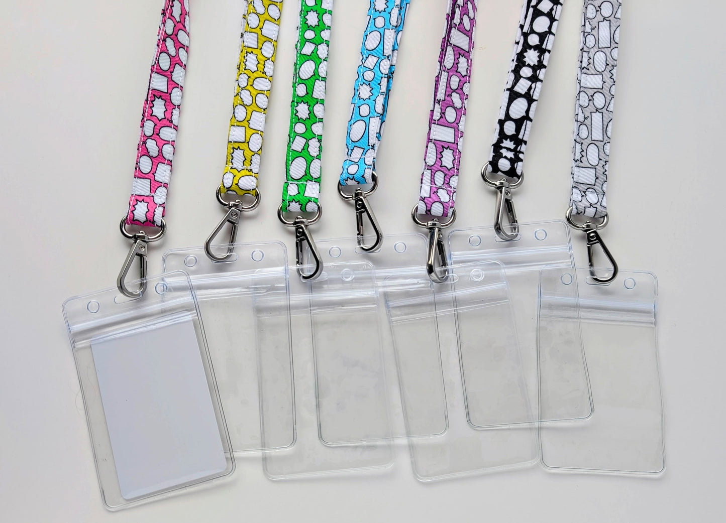 Set of colorful lanyards with clear badge holders on a white background