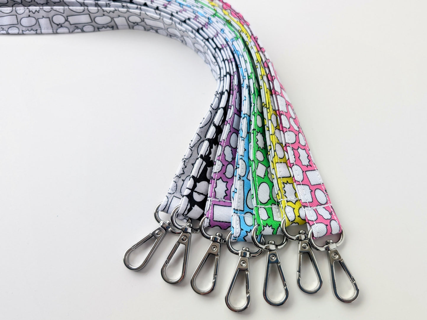Set of colorful lanyards with patterned designs on a white background