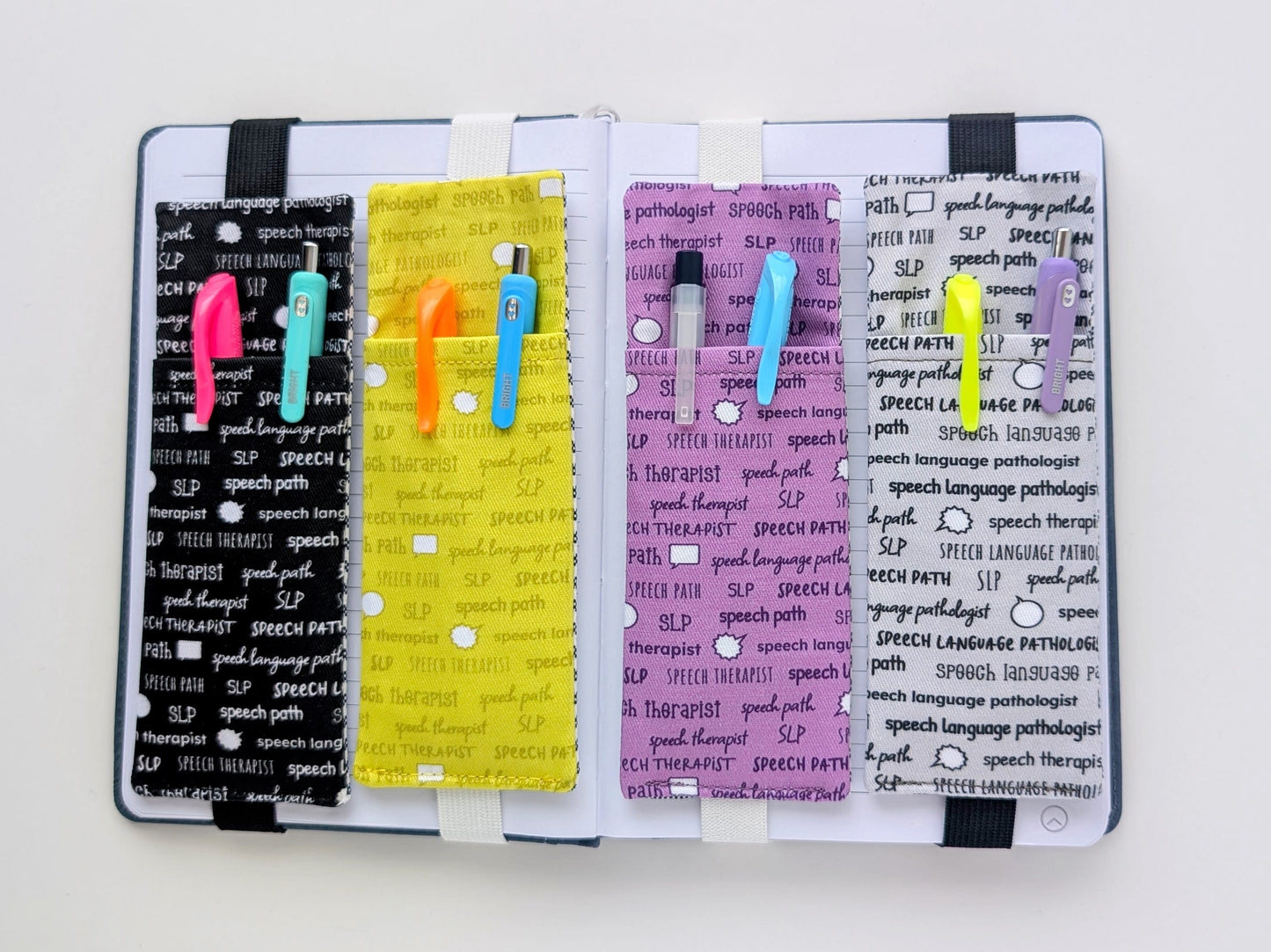 Four colorful bookmarks with text on a notebook on a white background