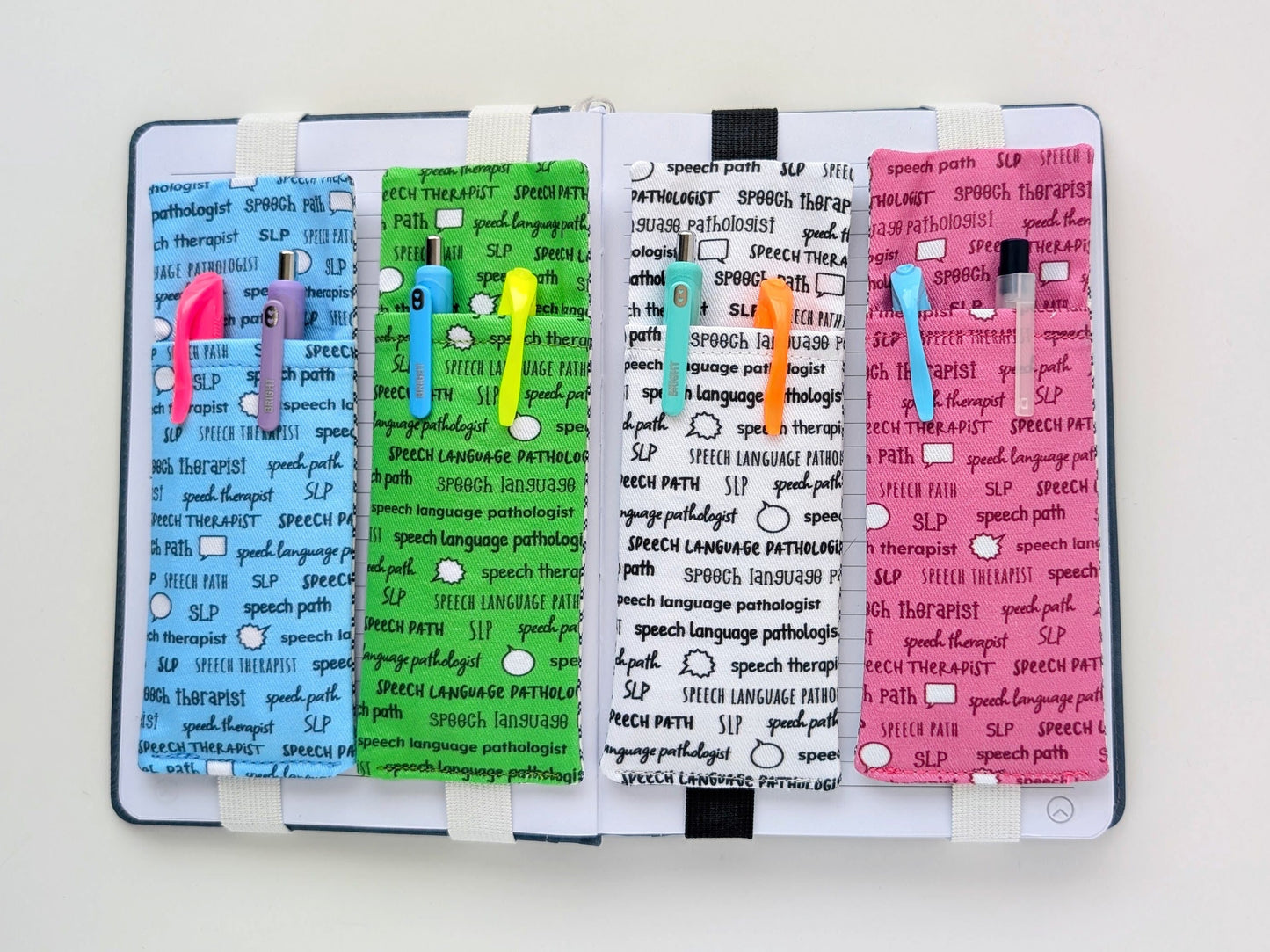 Four colorful bookmarks with text on a notebook on a white background
