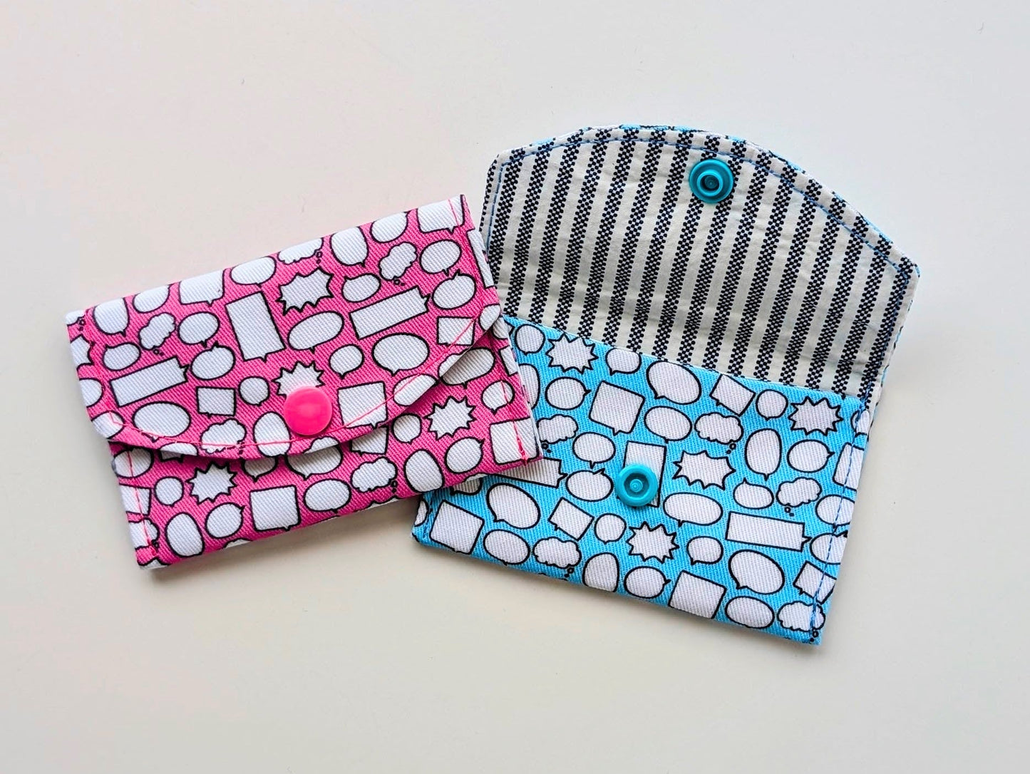 Two fabric pouches with different patterns on a light gray background