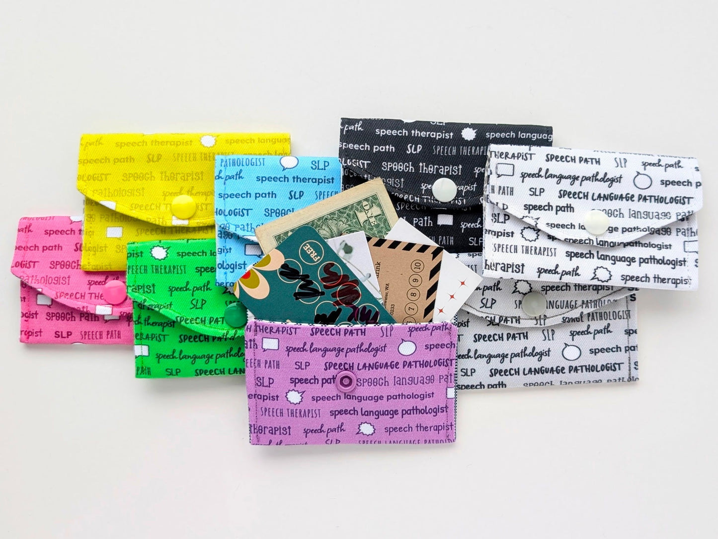 Colorful business card holders with speech language pathologist text on a white background