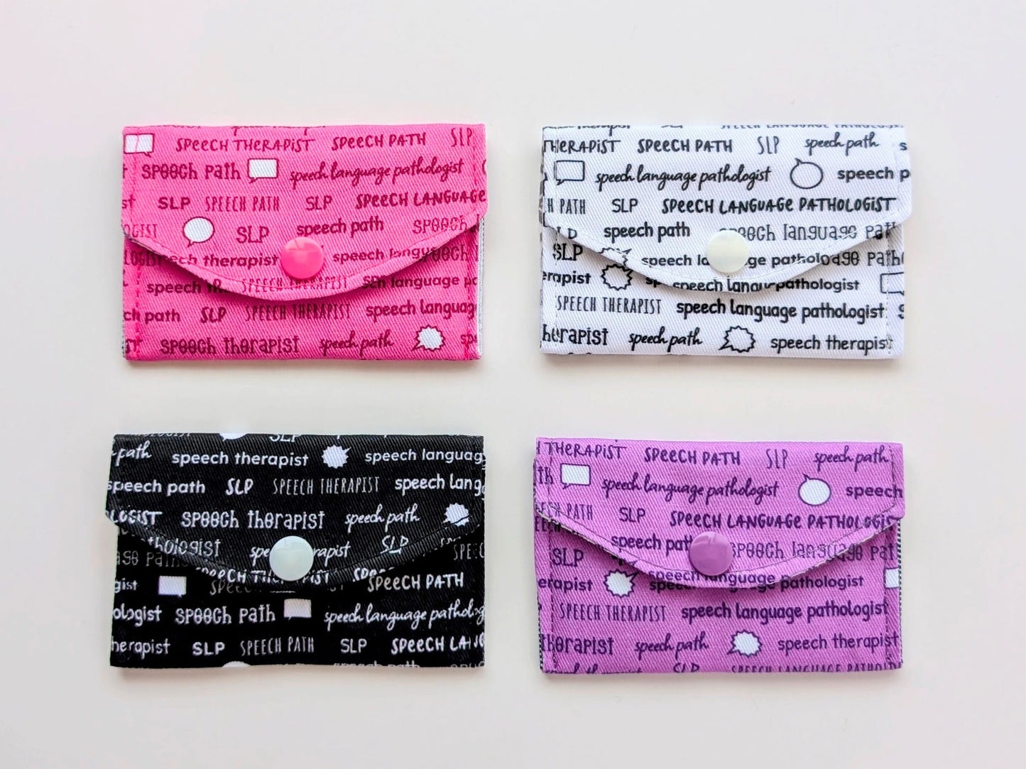 Four colorful business card holders with text on a white background