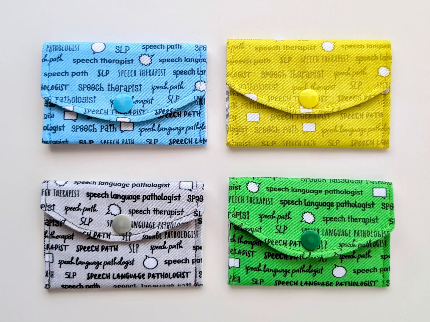 Four business card holders with text design on a white background