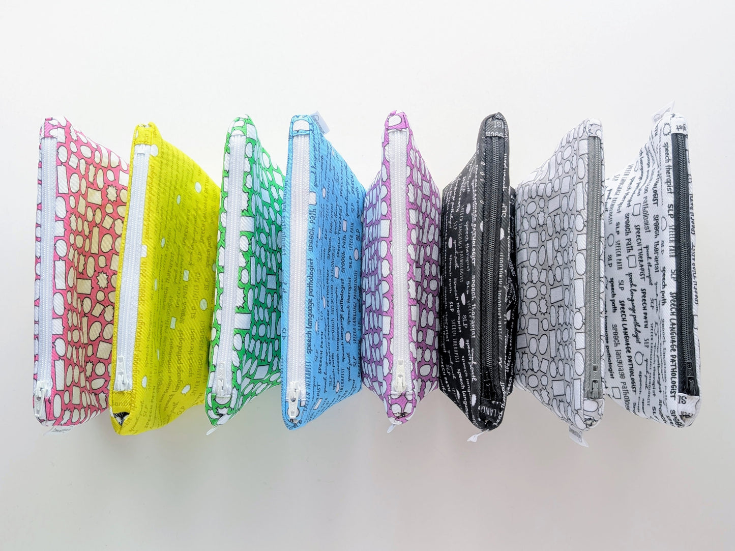 Set of colorful patterned pouches on a white background