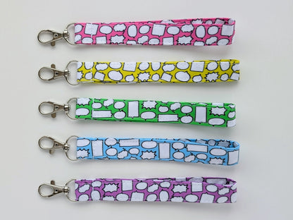 Five colorful keychains with different patterns on a white background