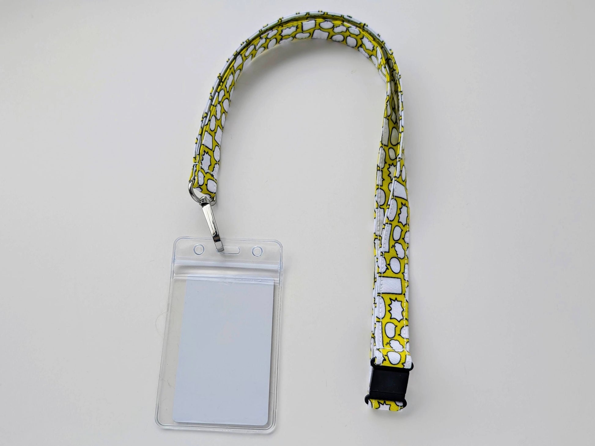 Lanyard with a clear ID badge holder on a light gray background
